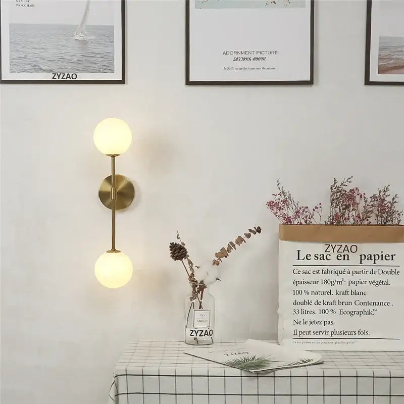 Gold-toned wall lamp decorbites golden glass led with two softly glowing spherical glass shades for bedroom sconce decor