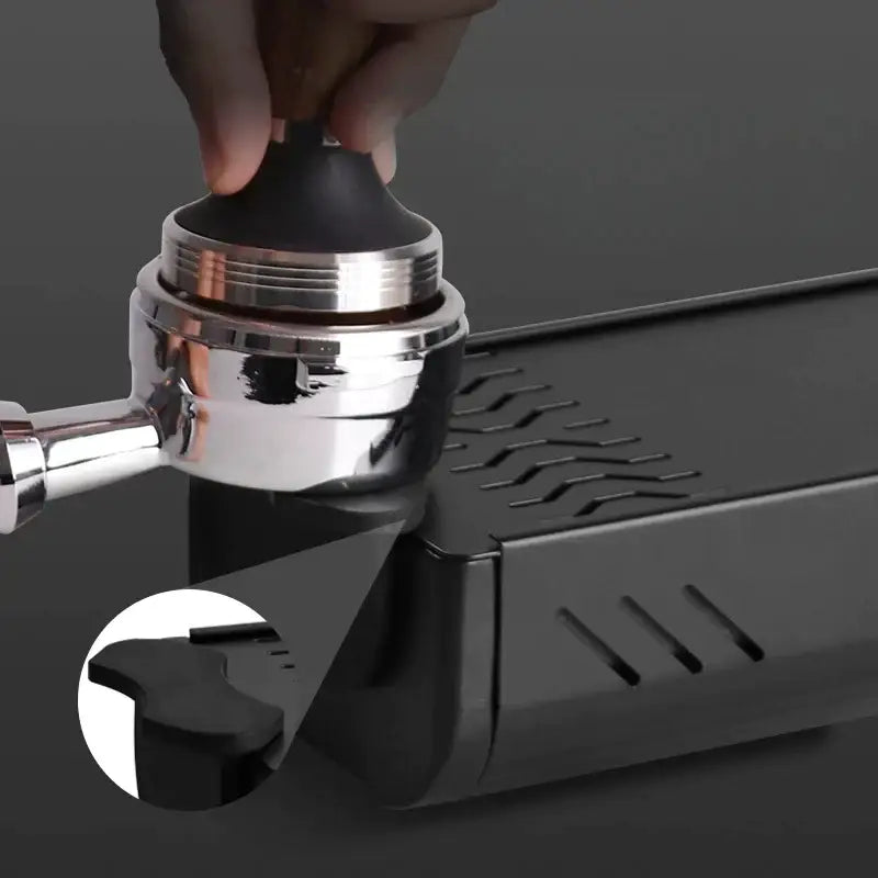 Black and silver espresso tamp with textured grip on black and green barista tamping station tray for kitchen organizers