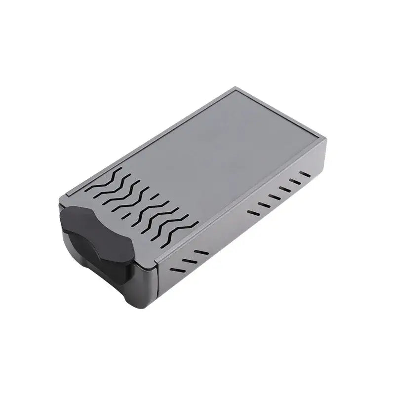 Gray rectangular knockbox grounds bin with black curved handle and wavy cutouts for barista tamping station tray
