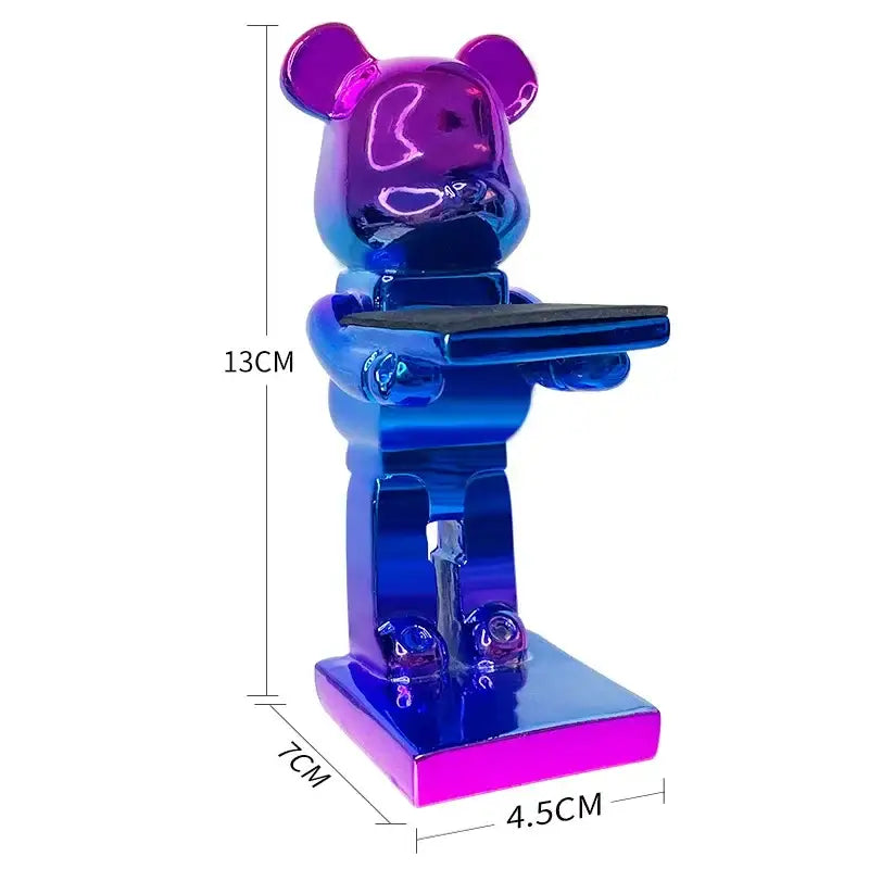 A glossy iridescent blue and purple cartoon bear watch stand holding a tray for bedroom decor