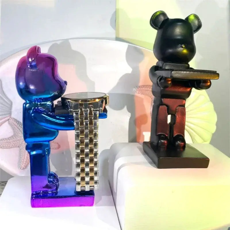 Vibrant black and iridescent purple cartoon bear watch stand holding a metallic link bracelet bear watch for bedroom decor
