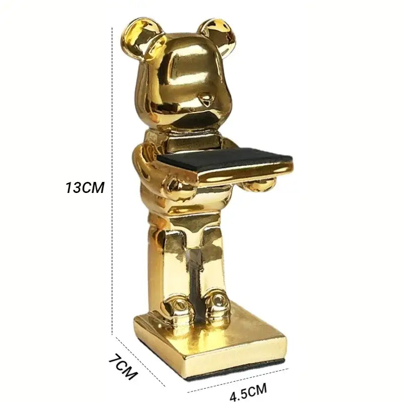Golden cartoon bear watch stand holding a black tray for bedroom decor with black and iridescent purple accents