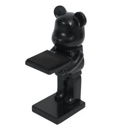 Black glossy cartoon bear watch stand holding a rectangular tray with iridescent purple accents for bedroom decor