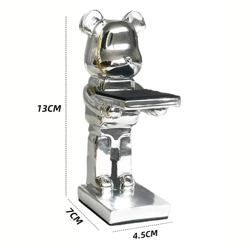 Silver metallic bear watch stand holding a black tray for black and iridescent purple cartoon bear bedroom decor