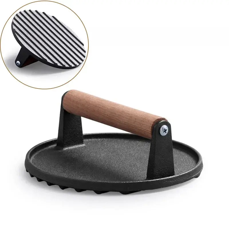 Black and light brown cast iron burger press with wooden handle and ribbed grilling surface by decorbites cast iron