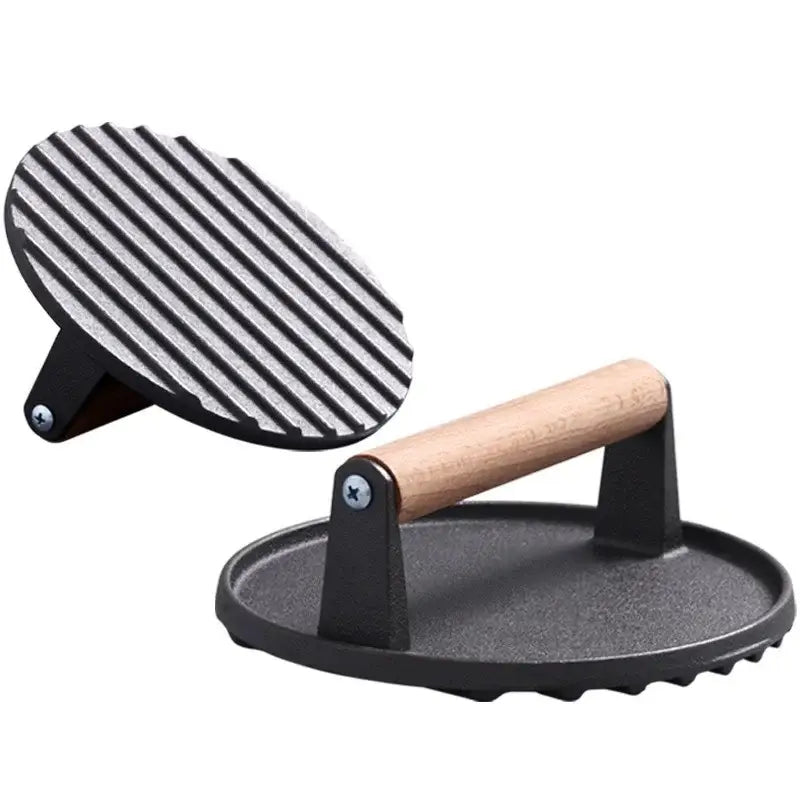 Black and light brown cast iron burger press with wooden handle and ribbed grilling surface by decorbites cast iron