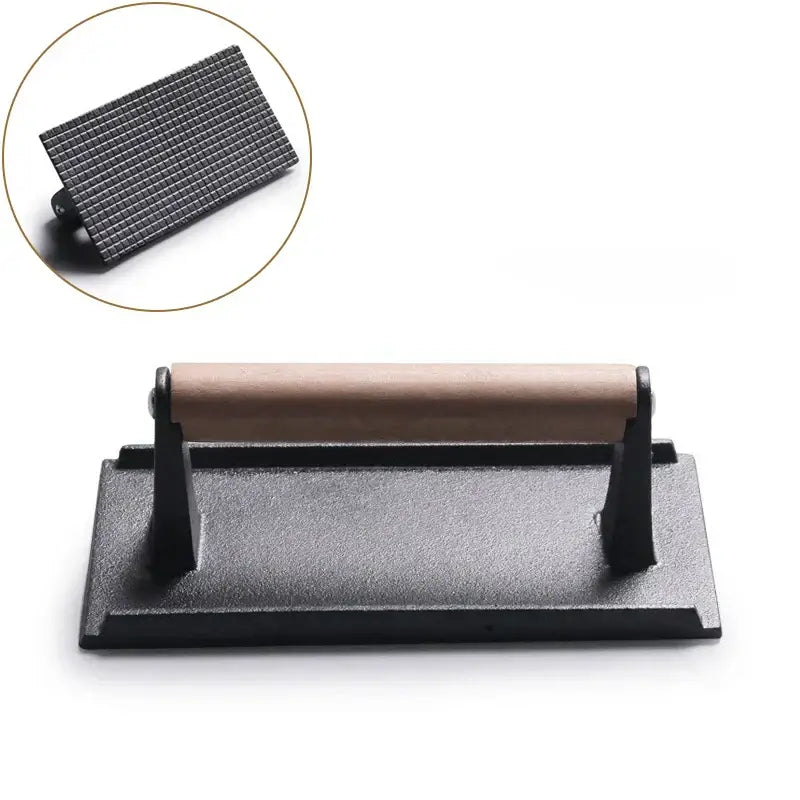 Black and light brown cast iron burger press kitchen meat tool with wooden handle and textured pressing surface decorbites cast iron