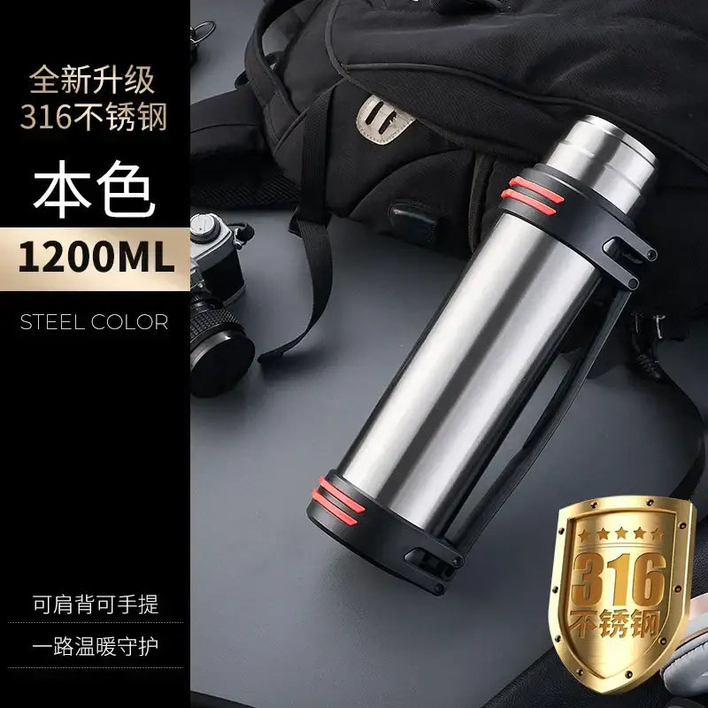 A sleek black and red insulated stainless steel outdoor travel flask with red grip bands and brushed metallic finish