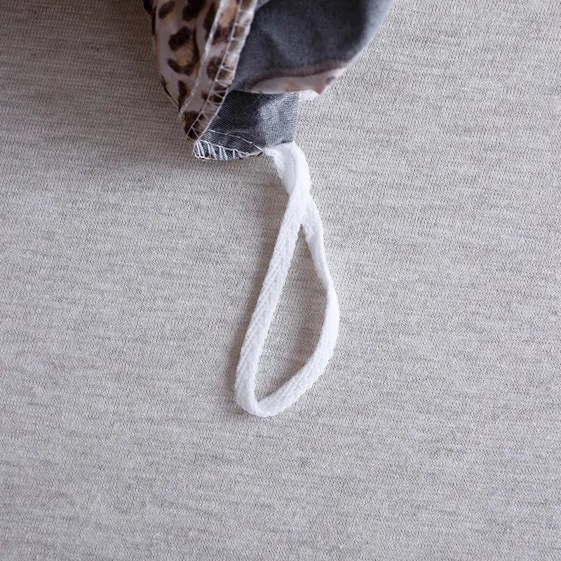 White braided drawstring loop on the back side of black and rose gold leopard print duvet set decorbites leopard print