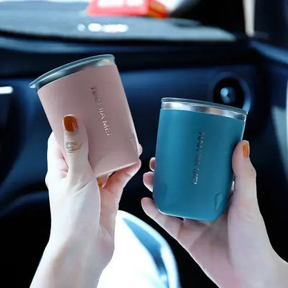 Two sleek 300ml stainless steel vacuum travel mugs in soft pink and teal with metallic lids and minimalist branding