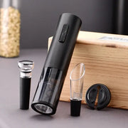 Black and silver electric corkscrew kit with transparent body, silver accent button, glass stoppers, and black rubber base