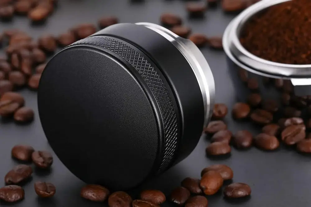 Black and silver espresso distributor coffee leveler with textured grip ring for enhanced brewing experience