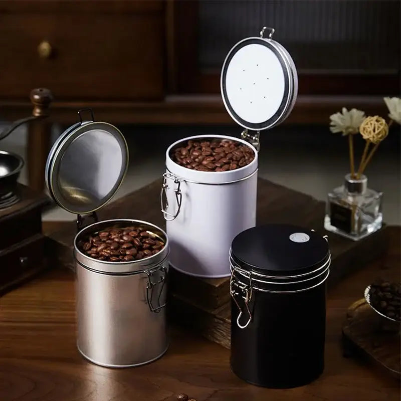 Three metal hermetic food storage pots in black silver and white with hinged lids for decorbites hermetic food use