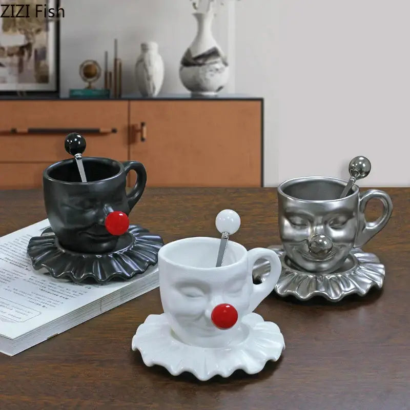 Set of three decorbites joker head cup and saucer porcelain coffee mugs in black white and silver with spoons
