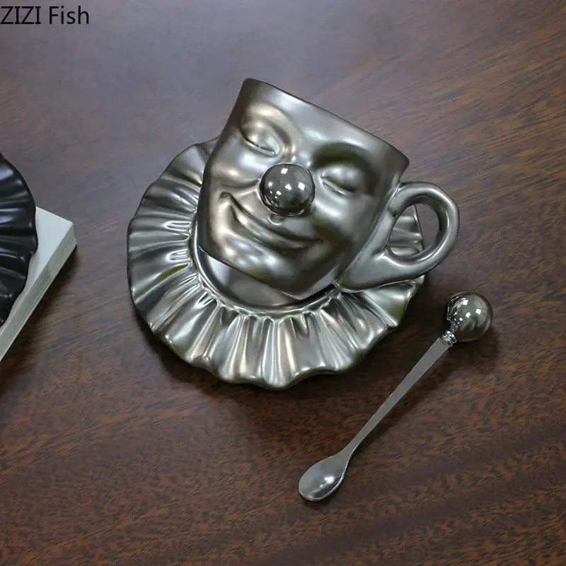Silver clown-faced joker head cup with ruffled collar design on matching saucer porcelain coffee set decorbites joker head