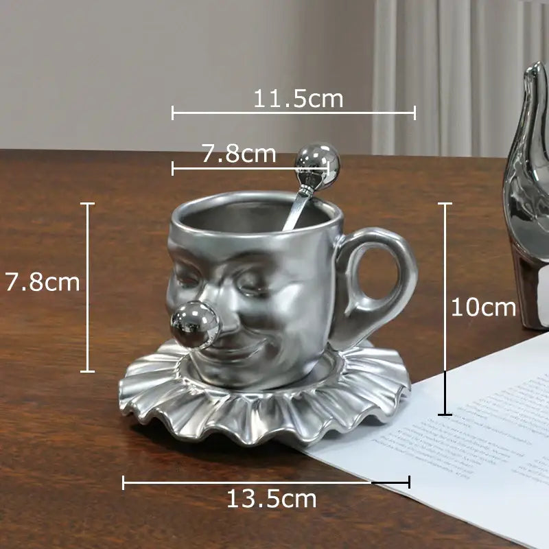 Silver joker head cup with ruffled saucer and matching spoon made of porcelain glossy finish decorbites joker head