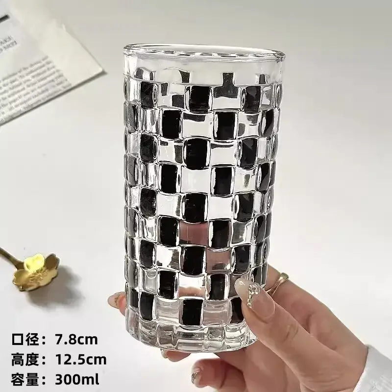Clear glass cups set with a black and silver mosaic pattern perfect for kitchen drinkware use