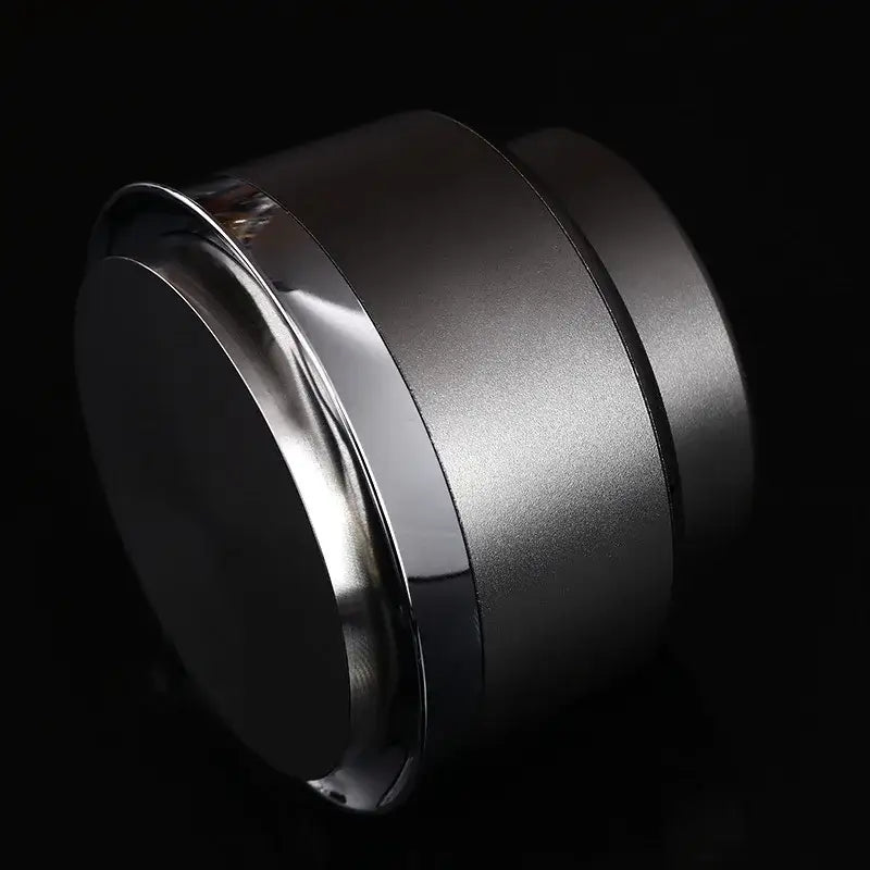 A sleek black and stainless steel decorbites adjustable coffee tamper with a brushed silver finish and polished chrome rim