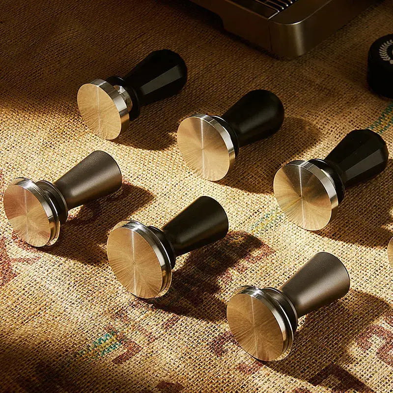 Set of six decorbites adjustable coffee tampers in black and brushed brass with cylindrical stainless steel handles