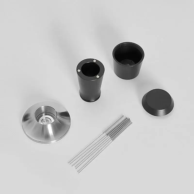 Black and stainless steel coffee distributor tamper set with precision-engineered metallic components and reflective base plate