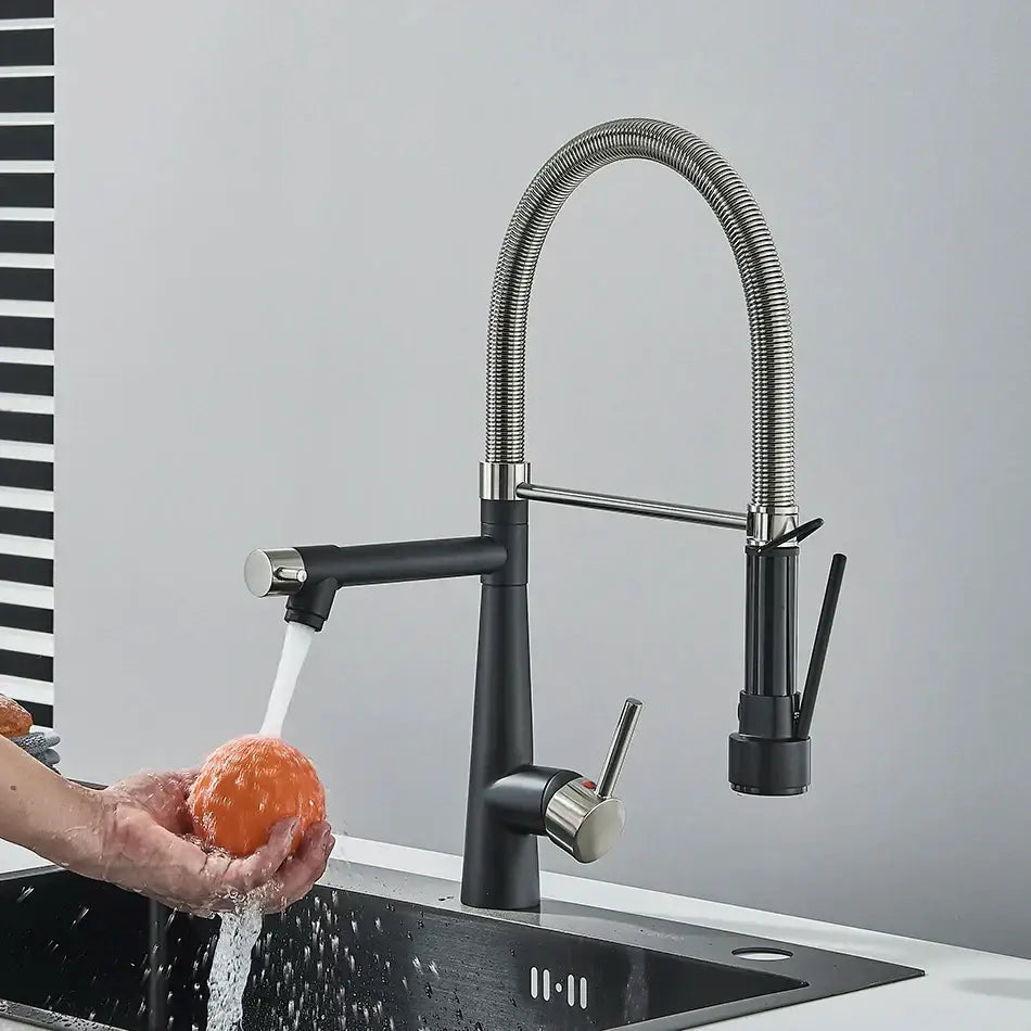 Black and stainless steel kitchen faucet with flexible ribbed chrome gooseneck spout and decorbites brass pull spray head
