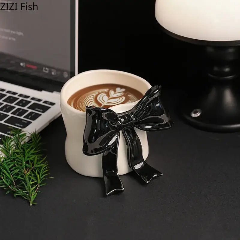 White porcelain coffee cup with glossy black bowknot designed for dining room and everyday coffee use