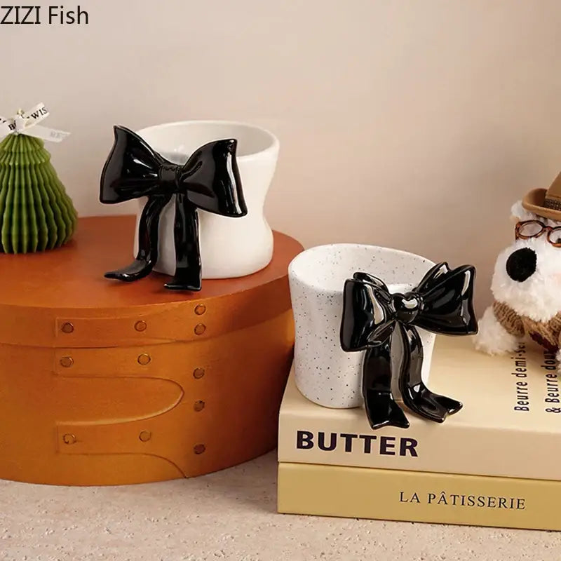 Black glossy bow-shaped porcelain coffee cup with a white speckled interior for dining room use