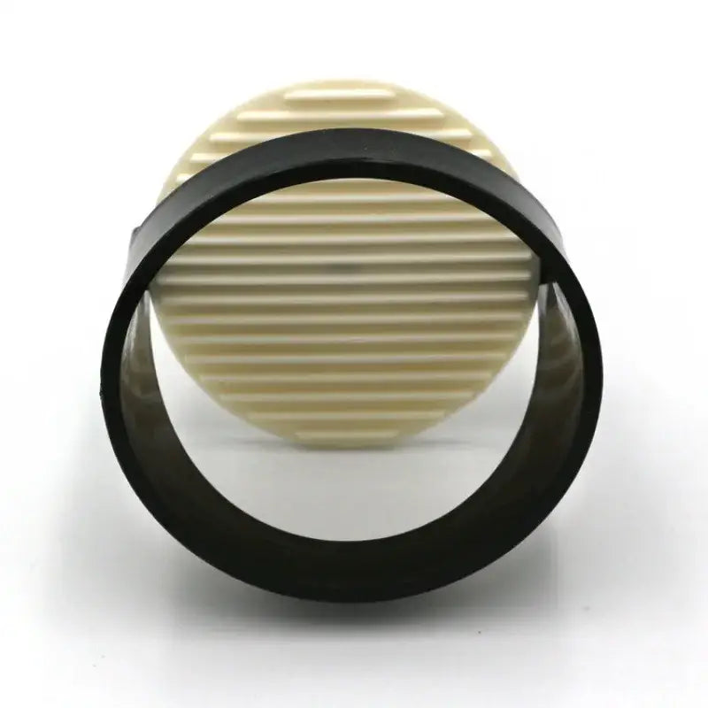 Black and cream circular filter with ribbed texture for decorbites burger press kitchen meat maker with spring handle