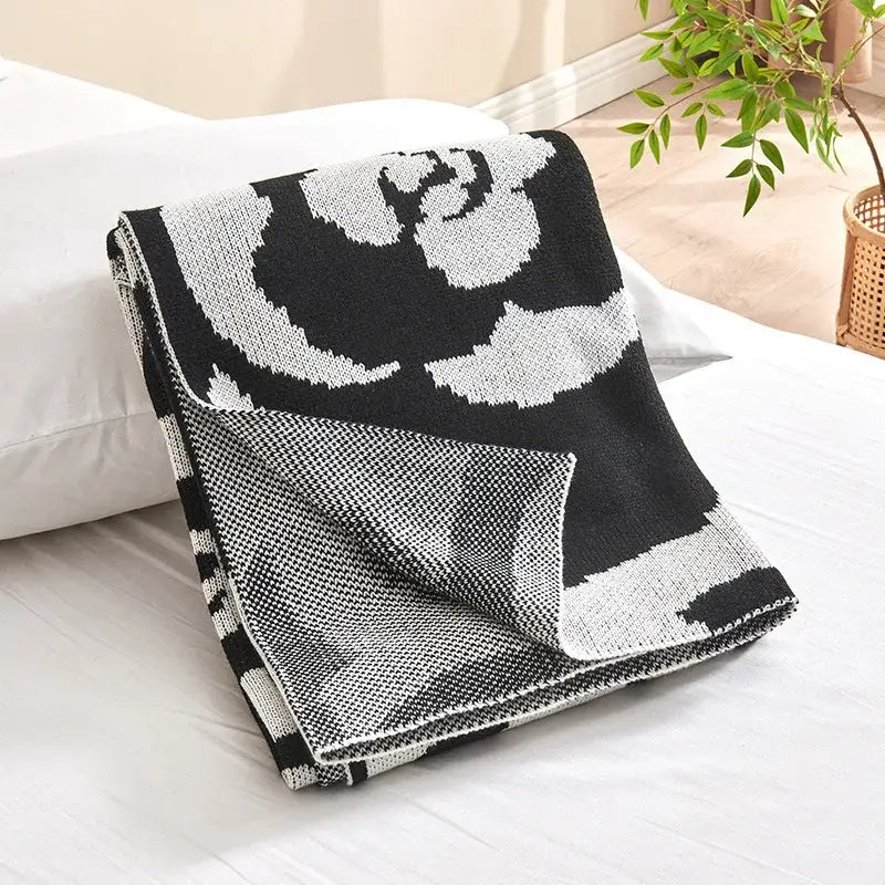 Black and white camellia knitted blanket with bold floral pattern and textured woven design for living room decorbites camellia