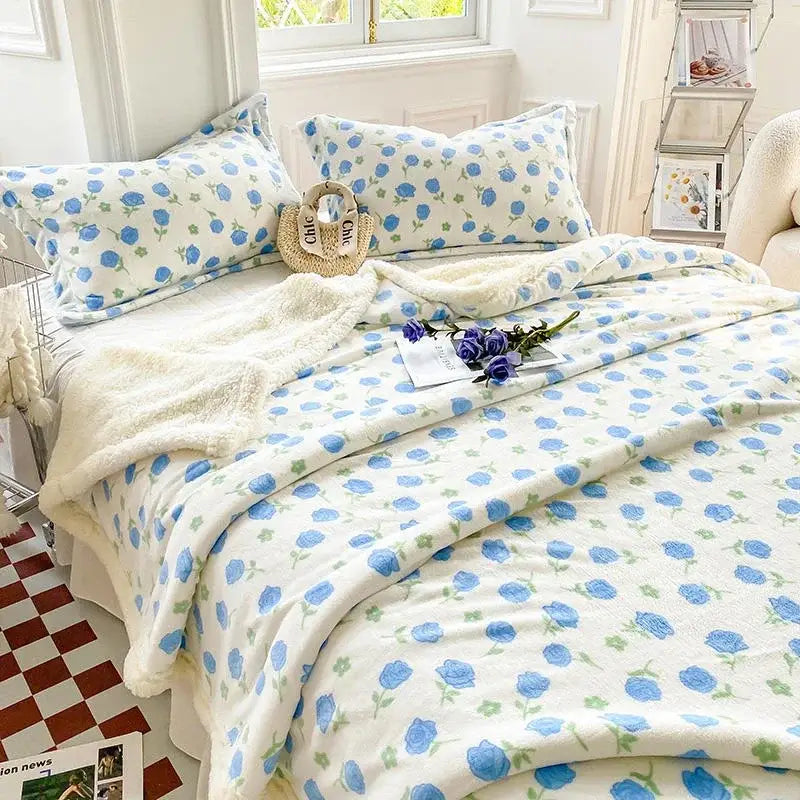 White plush cozy blanket with blue rose pattern and green stems from decorbites cartoon print sheep duvet set