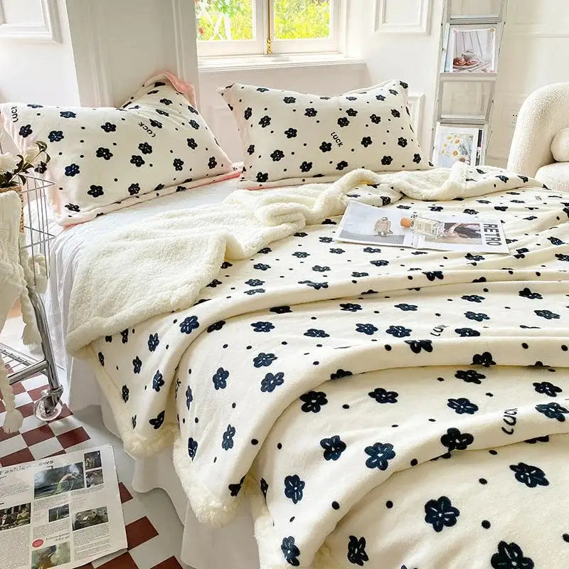 Cream-colored plush cozy blanket with black floral cartoon print and soft texture from decorbites cartoon print set