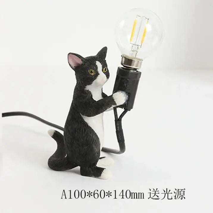 Black and white cat resin table lamp holding a clear bulb with filament for decorbites cat resin bedroom decor