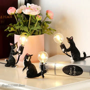 Black and white cat resin table lamp featuring figurines holding illuminated bulbs for bedroom decorbites cat resin decor