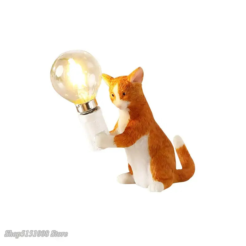 Orange and white cat resin table lamp holding a glowing bulb for bedroom decorbites cat resin table use