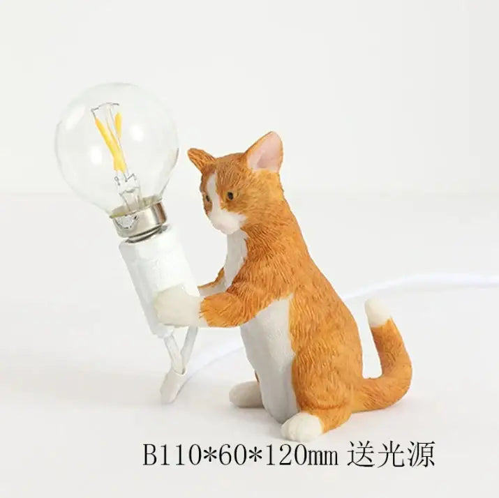 A charming orange and white decorbites cat resin table lamp holding a clear glass bulb for bedroom decor