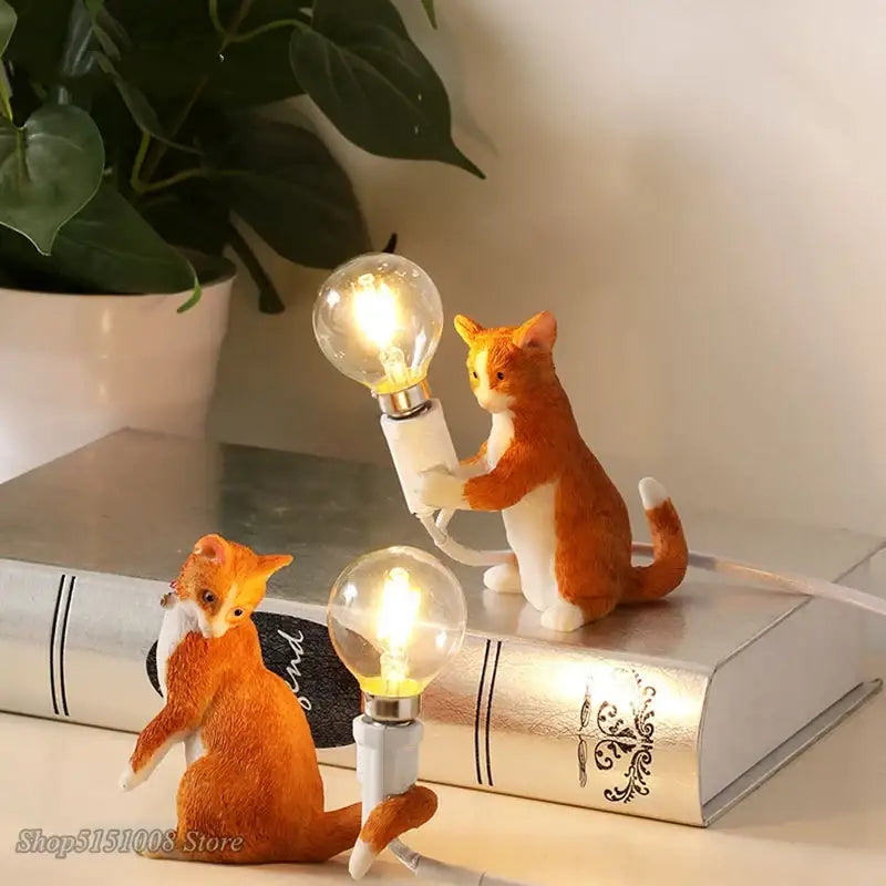 Black and white cat resin table lamp with orange and white resin cats holding illuminated edison bulbs for decorbites cat resin