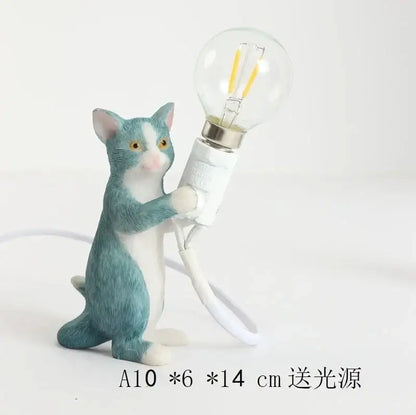 A teal and white ceramic cat resin table lamp holding a clear bulb designed as an adorable decorbites cat resin lamp