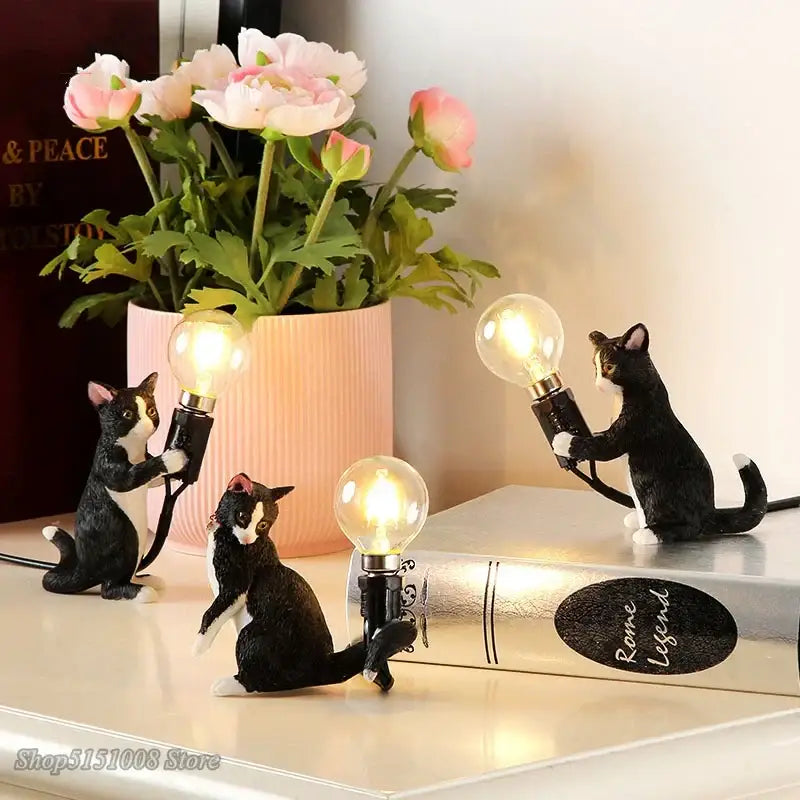 Black and white cat resin table lamp featuring three figurines holding glowing bulbs for bedroom decorbites cat resin use