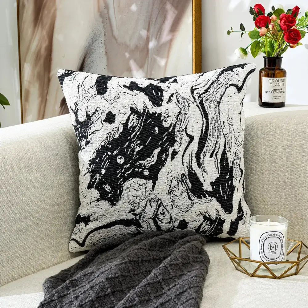 Black and white geometric chenille pillow cover with marbled pattern and textured fabric finish for living room decor