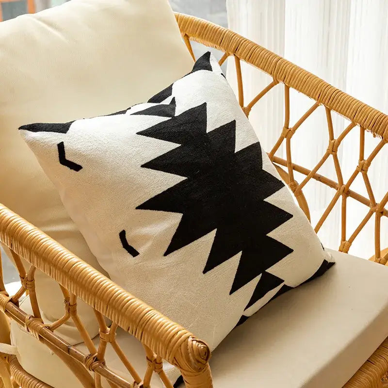 Cream-colored cushion cover with bold black geometric embroidered starburst pattern and soft stitched fabric decorbites geometric embroidered cushion