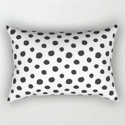 White rectangular pillow with black irregular polka dots featuring a geometric wave line design for bedroom decor