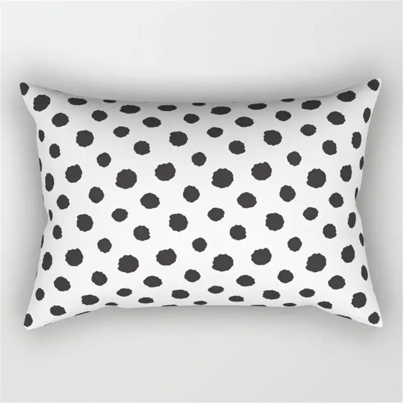 White rectangular pillow with black irregular polka dots featuring a geometric wave line design for bedroom decor