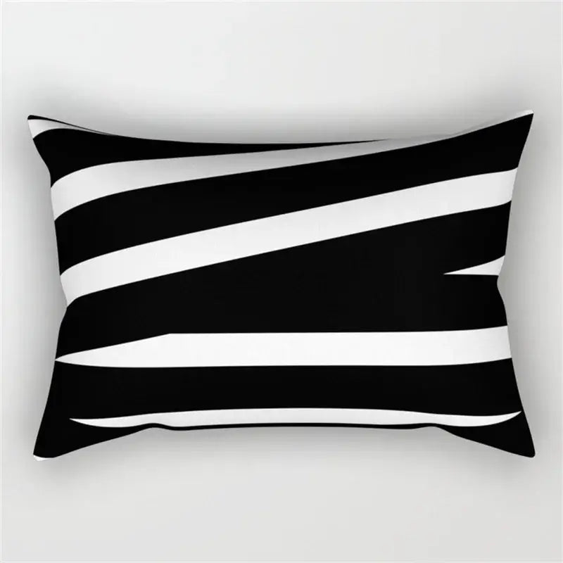 Rectangular pillow with bold black and white diagonal stripes featuring a geometric wave line design for bedroom decor