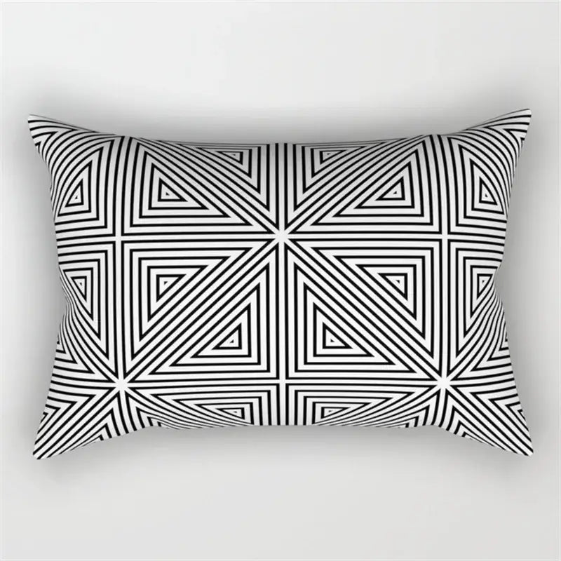 Rectangular pillow with a bold black and white geometric wave line pattern of interlocking triangles for bedroom decor