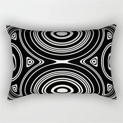 Rectangular black and white pillow with bold geometric wave line concentric circle pattern for bedroom decor