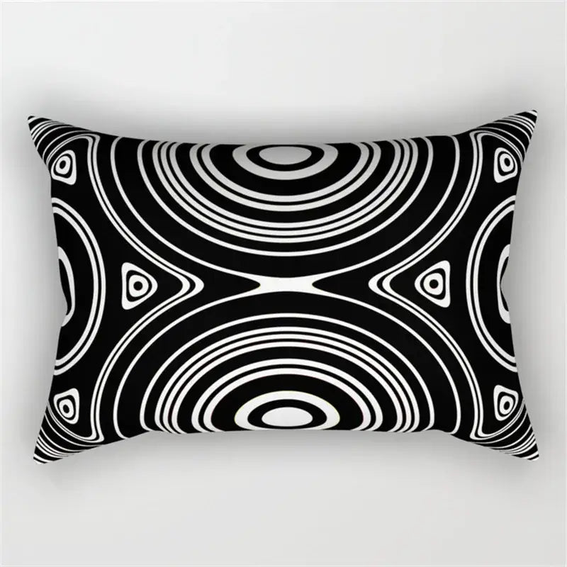 Rectangular black and white pillow with bold geometric wave line concentric circle pattern for bedroom decor