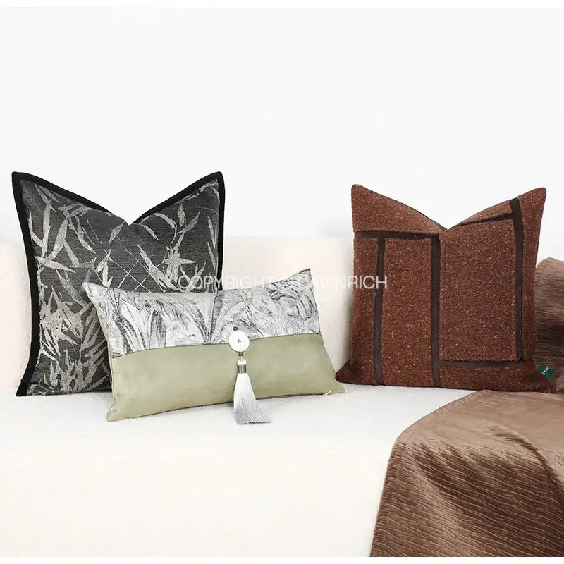 Olive green suede pillow cover with silver leaf pattern and white tassel accent featuring green jungle plants design