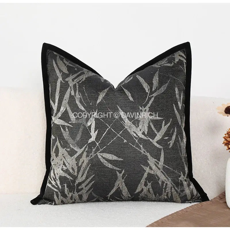 Black pillow cover with silver bamboo leaf pattern, velvet trim, and green jungle plants design for living room suede use