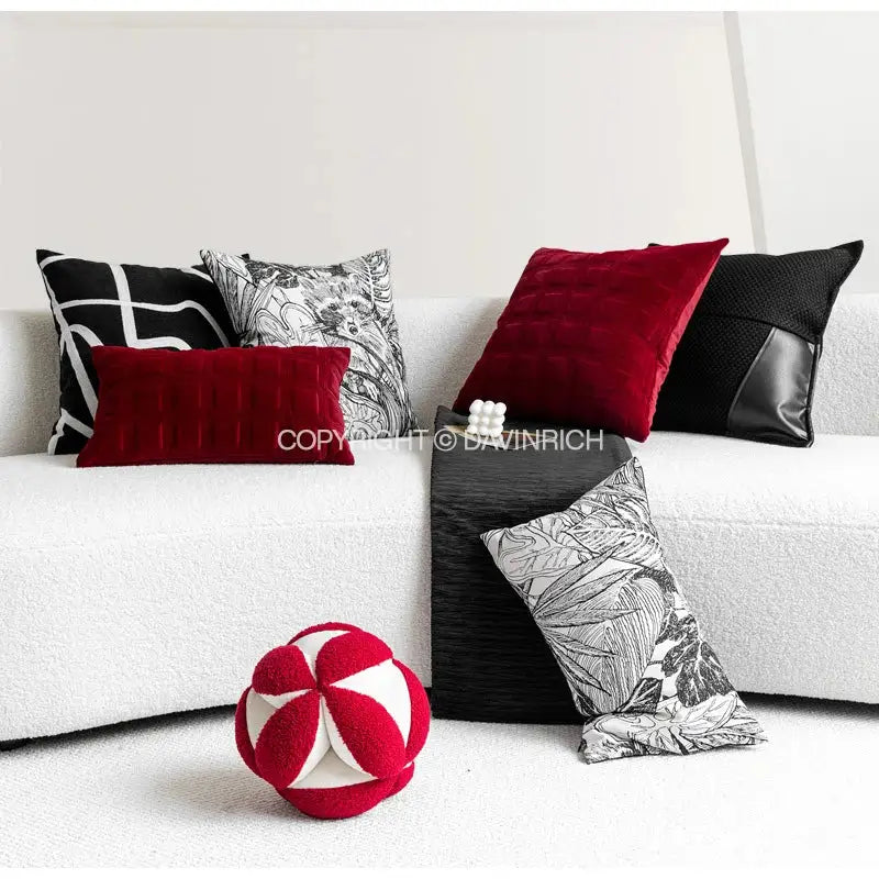 Red and white plush spherical toy complementing black and white jungle plant raccoon pillow cover decorbites decor