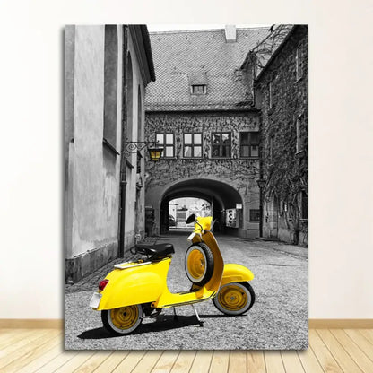Bright yellow vespa scooter with black seat and wheels parked under arched doorway beside decorbites black and white nordic landscape canvas set
